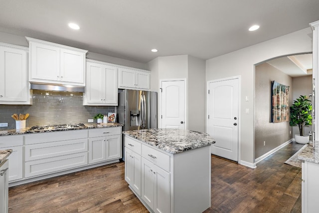 2313 Legend Hill Dr, Leander, TX 78641 - kitchen with stainless steel appliances, under cabinet range hood, white cabinets, tasteful backsplash, and recessed lighting