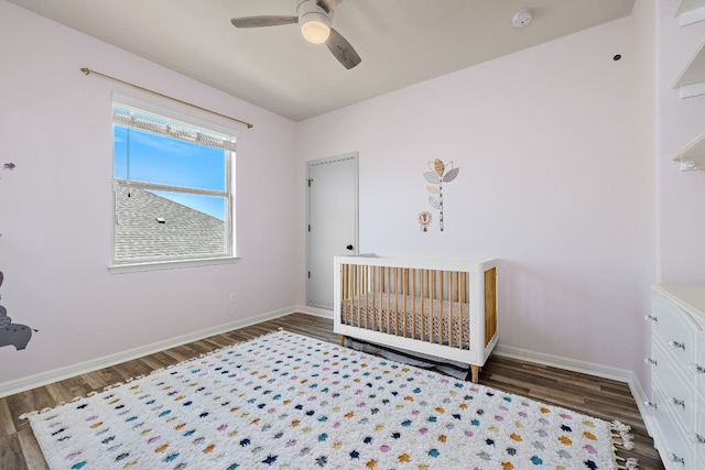 2313 Legend Hill Dr, Leander, TX 78641 - unfurnished bedroom featuring wood finished floors, a ceiling fan, and a nursery area