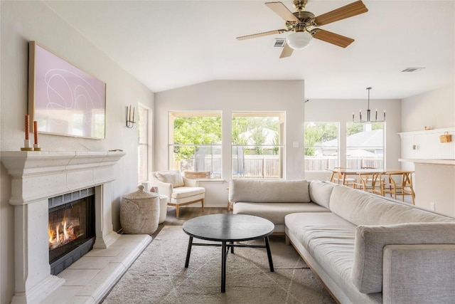 8908 Campo Verde Ct, Austin, TX 78749 - living area featuring lofted ceiling, a tiled fireplace, and a ceiling fan