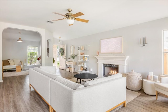 8908 Campo Verde Ct, Austin, TX 78749 - living area with arched walkways, ceiling fan, and wood finished floors
