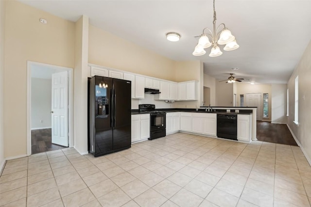11201 Canterbury Tales Ln, Austin, TX 78748 - kitchen with black appliances, dark countertops, vaulted ceiling, a chandelier, and under cabinet range hood