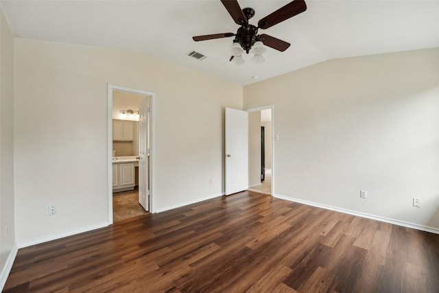11201 Canterbury Tales Ln, Austin, TX 78748 - unfurnished bedroom with wood finished floors, baseboards, vaulted ceiling, connected bathroom, and a ceiling fan