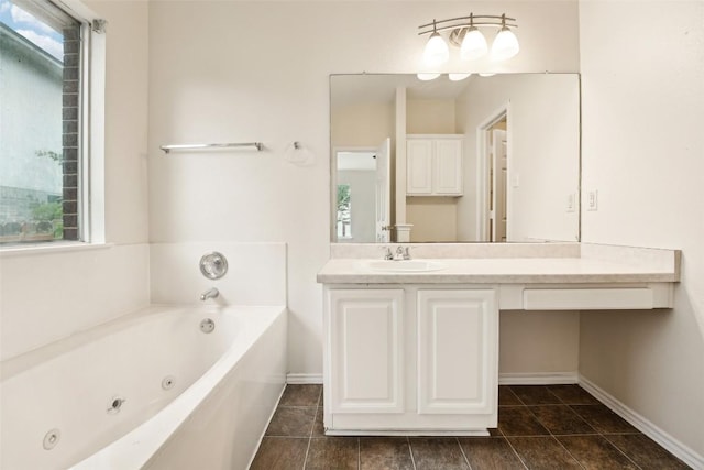 11201 Canterbury Tales Ln, Austin, TX 78748 - full bath with a tub with jets, vanity, baseboards, and tile patterned floors