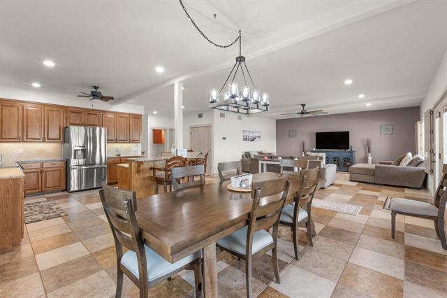 1002 Scenic Loop, Kingsland, TX 78639 - dining room with ceiling fan, recessed lighting, light tile patterned floors, and a chandelier