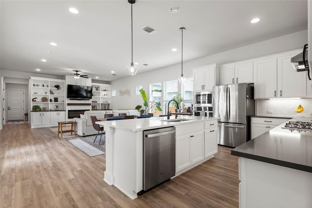 8904 Apogee Blvd, Austin, TX 78744 - kitchen featuring appliances with stainless steel finishes, a sink, a ceiling fan, recessed lighting, and white cabinetry