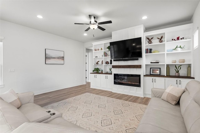 8904 Apogee Blvd, Austin, TX 78744 - living area with a ceiling fan, light wood-type flooring, baseboards, recessed lighting, and a large fireplace