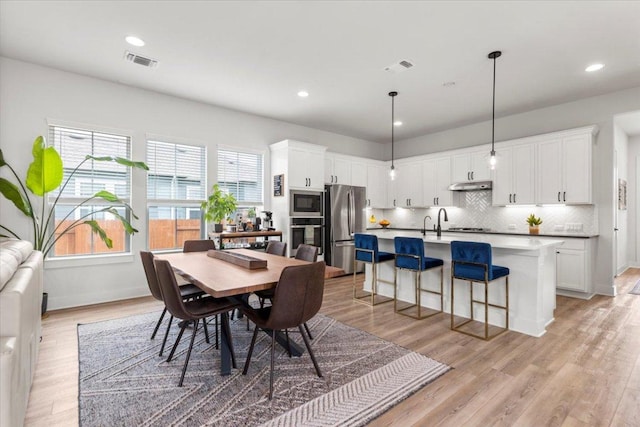 8904 Apogee Blvd, Austin, TX 78744 - dining space with light wood finished floors and recessed lighting