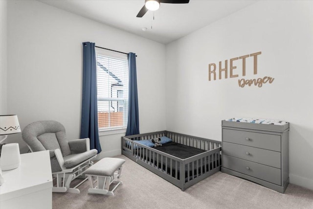 8904 Apogee Blvd, Austin, TX 78744 - carpeted bedroom with a crib, a ceiling fan, and baseboards