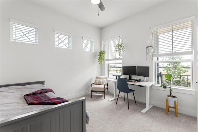 8904 Apogee Blvd, Austin, TX 78744 - bedroom with light carpet, an office area, baseboards, and ceiling fan