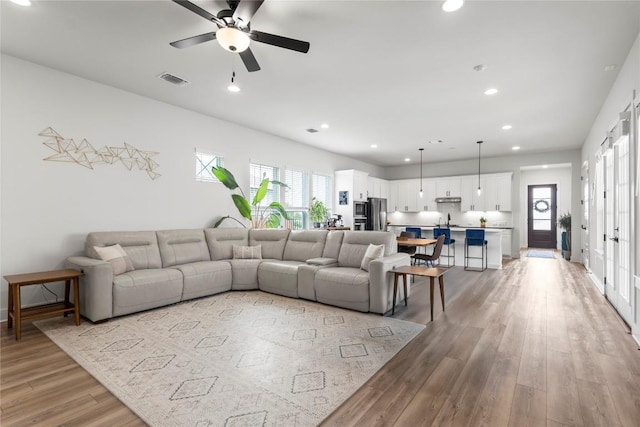 8904 Apogee Blvd, Austin, TX 78744 - living room featuring light wood-type flooring, recessed lighting, and a ceiling fan
