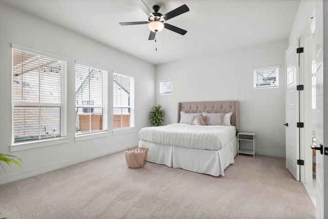 8904 Apogee Blvd, Austin, TX 78744 - bedroom with baseboards, light colored carpet, and ceiling fan