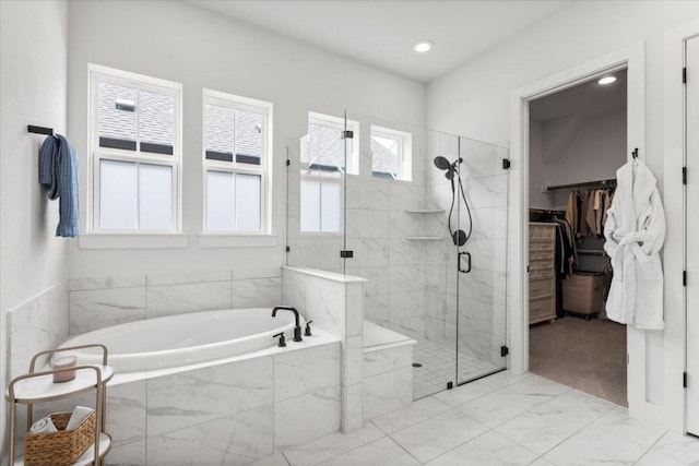 8904 Apogee Blvd, Austin, TX 78744 - full bathroom with a garden tub, a stall shower, a spacious closet, and recessed lighting