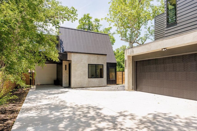 4506 Clawson Rd Unit 2, Austin, TX 78745 - view of front of property featuring driveway, metal roof, and stucco siding