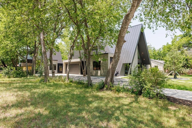 4506 Clawson Rd Unit 2, Austin, TX 78745 - view of front of house with a standing seam roof, a garage, metal roof, a front lawn, and driveway