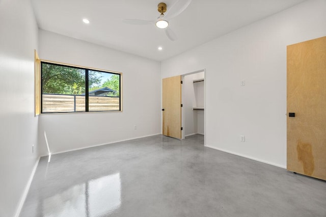 4506 Clawson Rd Unit 2, Austin, TX 78745 - unfurnished bedroom with finished concrete flooring, baseboards, ceiling fan, a spacious closet, and recessed lighting