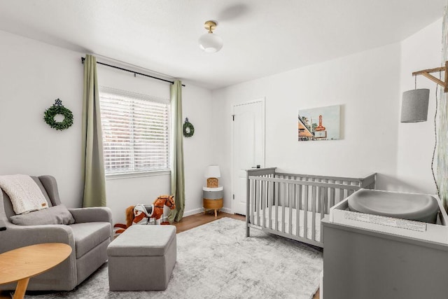3712 Sawmill Dr, Austin, TX 78749 - bedroom with a nursery area, wood finished floors, and baseboards