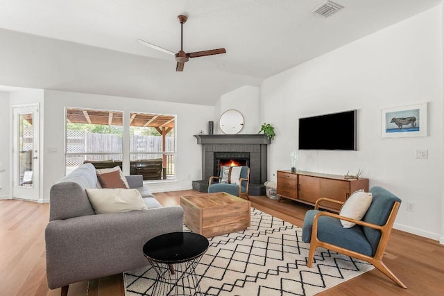 3712 Sawmill Dr, Austin, TX 78749 - living room with a ceiling fan, lofted ceiling, a fireplace, light wood-type flooring, and baseboards