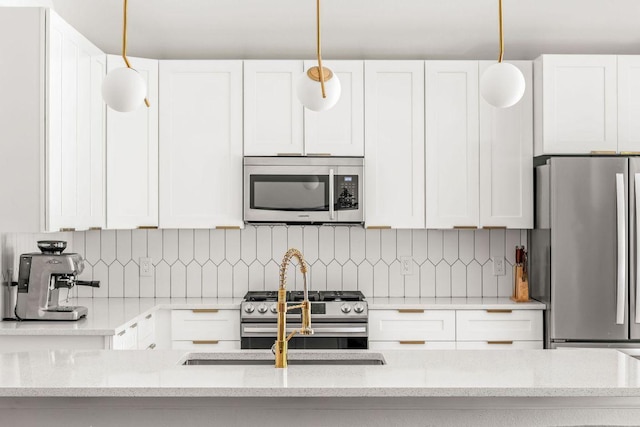 3712 Sawmill Dr, Austin, TX 78749 - kitchen featuring stainless steel appliances, white cabinetry, light stone countertops, and a sink