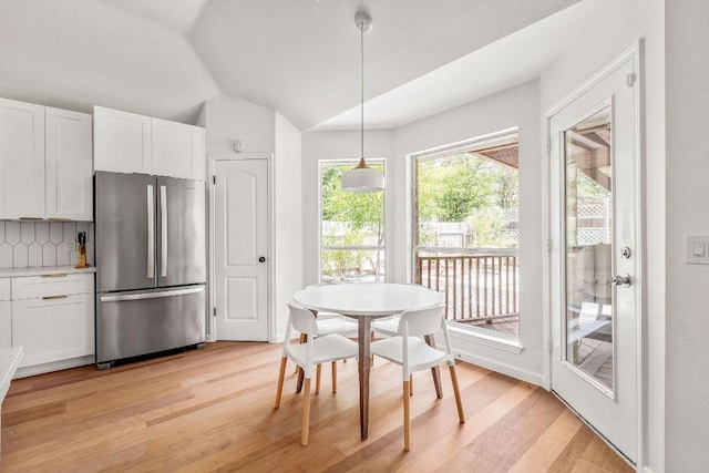 3712 Sawmill Dr, Austin, TX 78749 - dining space featuring light wood-style flooring and vaulted ceiling