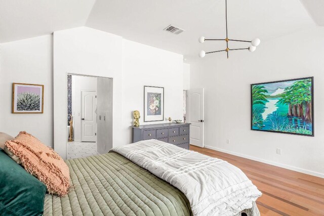 3712 Sawmill Dr, Austin, TX 78749 - bedroom featuring a chandelier, wood finished floors, vaulted ceiling, and baseboards