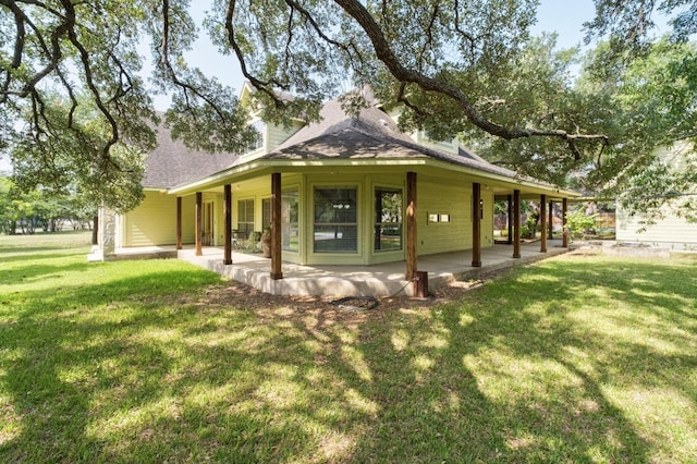 400 S Sledge St, Kyle, TX 78640 - view of home's exterior with a lawn, a shingled roof, and a patio