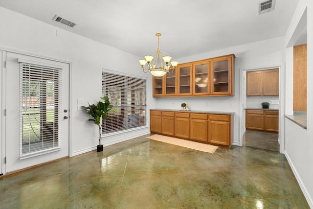 400 S Sledge St, Kyle, TX 78640 - unfurnished dining area featuring finished concrete floors, baseboards, and a chandelier