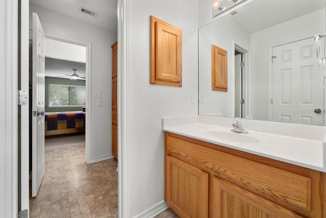 400 S Sledge St, Kyle, TX 78640 - ensuite bathroom featuring vanity, baseboards, and ceiling fan