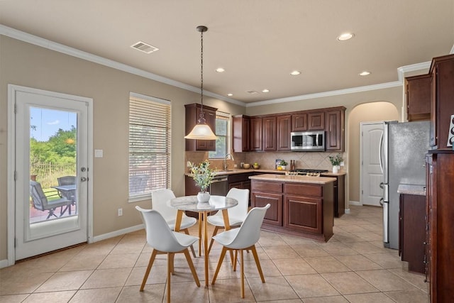 3517 Shellcastle Ln, Round Rock, TX 78681 - kitchen featuring appliances with stainless steel finishes, light countertops, light tile patterned floors, ornamental molding, and recessed lighting