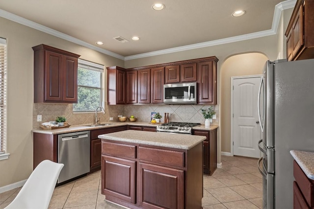 3517 Shellcastle Ln, Round Rock, TX 78681 - kitchen with stainless steel appliances, light tile patterned floors, decorative backsplash, recessed lighting, and ornamental molding