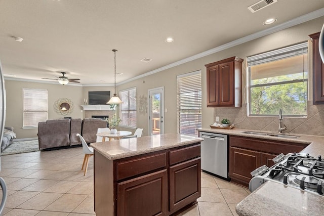 3517 Shellcastle Ln, Round Rock, TX 78681 - kitchen with dishwasher, light tile patterned floors, a fireplace, light countertops, and crown molding