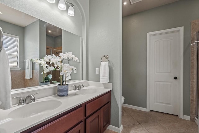3517 Shellcastle Ln, Round Rock, TX 78681 - bathroom featuring a shower stall, double vanity, and tile patterned floors