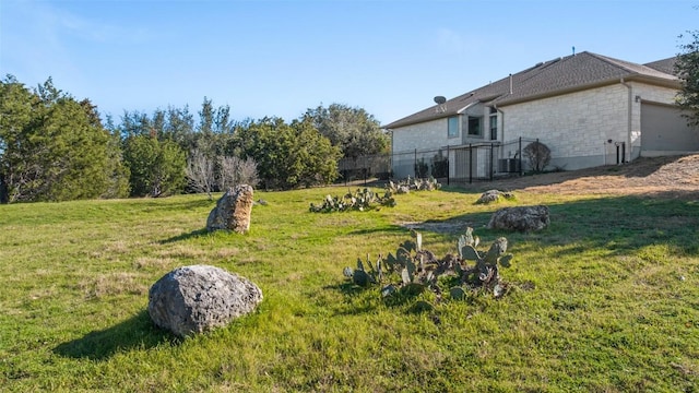5501 Wild Foxglove Rd, Spicewood, TX 78669 - view of yard featuring an attached garage and cooling unit