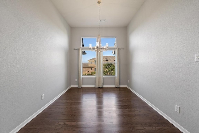 5501 Wild Foxglove Rd, Spicewood, TX 78669 - unfurnished dining area featuring a chandelier, dark wood-style floors, a textured wall, and baseboards