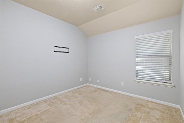 5501 Wild Foxglove Rd, Spicewood, TX 78669 - carpeted empty room featuring vaulted ceiling and baseboards