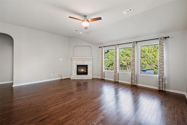 5501 Wild Foxglove Rd, Spicewood, TX 78669 - unfurnished living room featuring a glass covered fireplace, vaulted ceiling, ceiling fan, dark wood-style floors, and baseboards