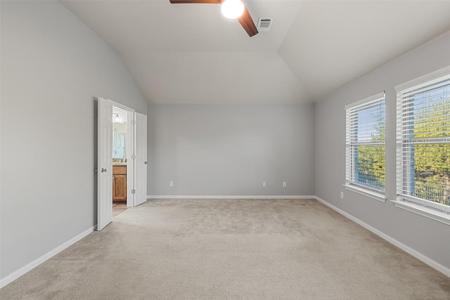 5501 Wild Foxglove Rd, Spicewood, TX 78669 - empty room with light colored carpet, vaulted ceiling, ceiling fan, and baseboards