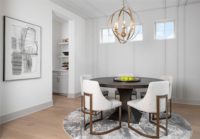 225 Hazy Hills Loop, Dripping Springs, TX 78620 - dining room with a chandelier, light wood-type flooring, built in features, and baseboards