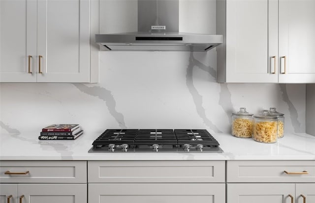 225 Hazy Hills Loop, Dripping Springs, TX 78620 - kitchen featuring exhaust hood, stainless steel gas cooktop, light countertops, and white cabinetry