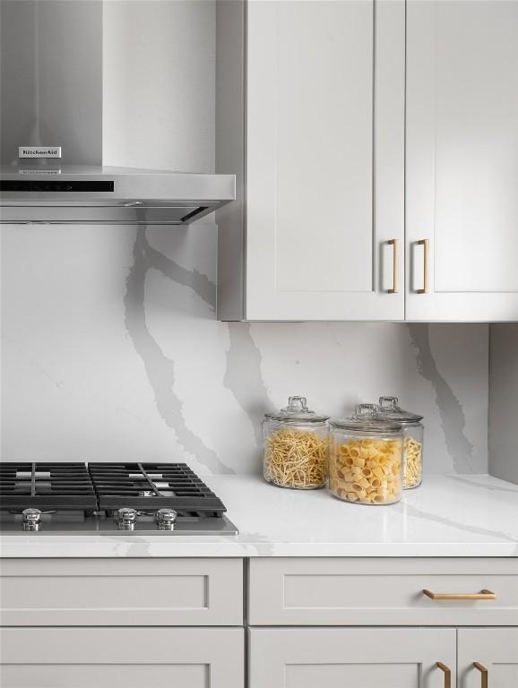 225 Hazy Hills Loop, Dripping Springs, TX 78620 - kitchen with exhaust hood, light countertops, stainless steel gas cooktop, and white cabinets