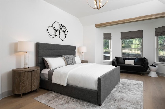 225 Hazy Hills Loop, Dripping Springs, TX 78620 - bedroom featuring wood finished floors, vaulted ceiling, and a chandelier