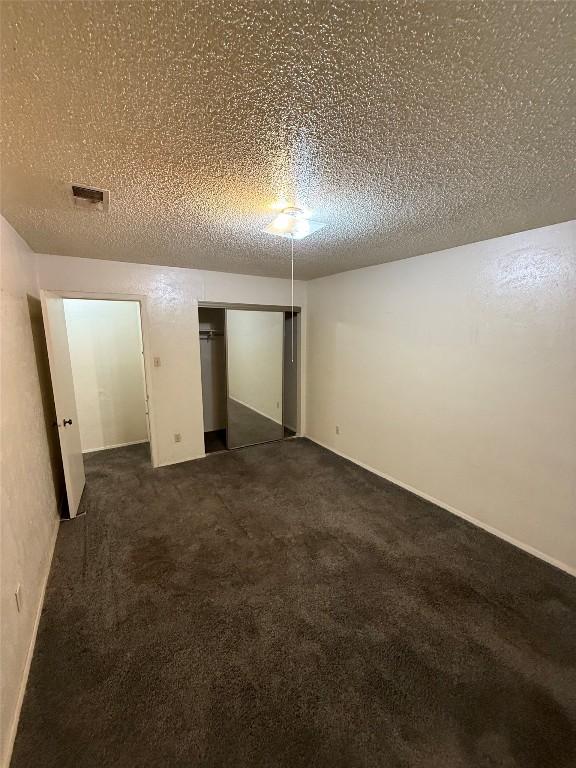 10502 Golden Meadow Dr, Austin, TX 78758 - finished basement with dark carpet and a textured ceiling