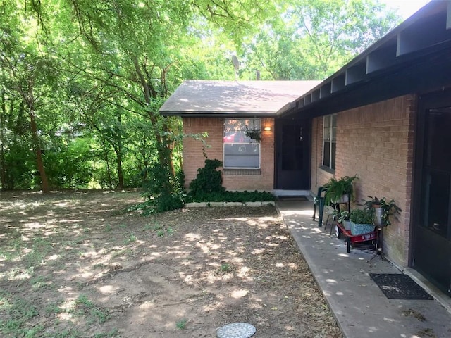 2403 Sherwood Ln, Austin, TX 78704 - entrance to property featuring brick siding and a shingled roof