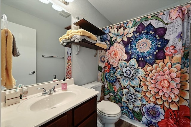 8505 Shallot Way, Austin, TX 78748 - bathroom with toilet, vanity, wood finished floors, and curtained shower
