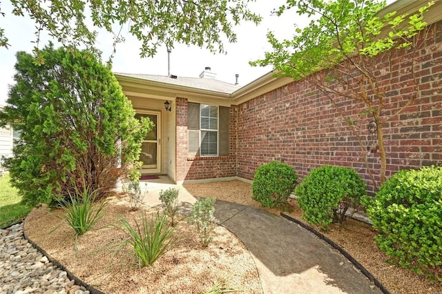 8505 Shallot Way, Austin, TX 78748 - entrance to property with brick siding and a chimney