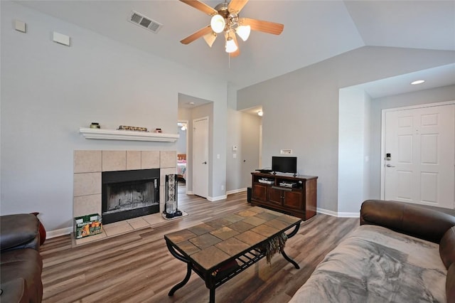 8505 Shallot Way, Austin, TX 78748 - living room with a ceiling fan, light wood-type flooring, baseboards, a tiled fireplace, and lofted ceiling