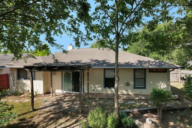 5808 Spring Meadow Rd, Austin, TX 78744 - view of front of home featuring a chimney, a patio, and roof with shingles