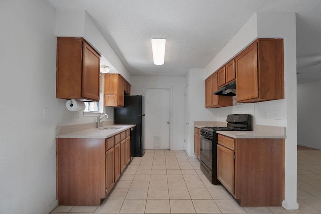 5808 Spring Meadow Rd, Austin, TX 78744 - kitchen with black appliances, under cabinet range hood, light countertops, a sink, and brown cabinets