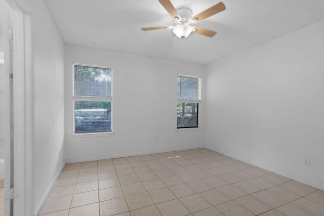 5808 Spring Meadow Rd, Austin, TX 78744 - empty room with a textured ceiling, ceiling fan, baseboards, and light tile patterned floors