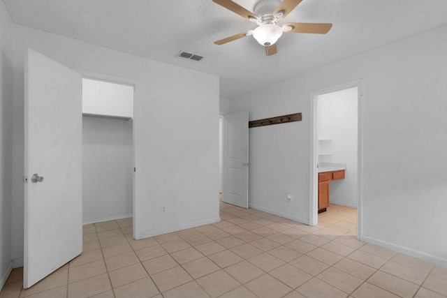 5808 Spring Meadow Rd, Austin, TX 78744 - unfurnished bedroom featuring a walk in closet, a closet, baseboards, and ceiling fan