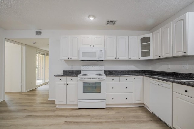 8600 Fathom Cir Unit 1303, Austin, TX 78750 - kitchen featuring white appliances, white cabinets, glass insert cabinets, and a textured ceiling